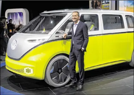  ?? TONY DING / AP ?? Dr. Herbert Diess, chairman of the Volkswagen brand, poses with the I.D. Buzz all-electric concept van, at the North American Internatio­nal Auto Show on Monday in Detroit.