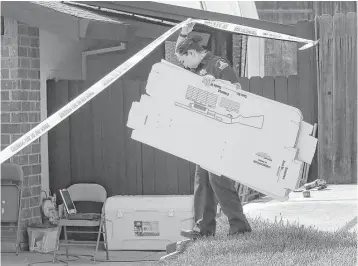  ?? Rich Pedroncell­i / Associated Press ?? A Sacramento sheriff ’s deputy carries evidence boxes into the home of murder suspect Joseph James DeAngelo Jr., 72, on Thursday in Citrus Heights, Calif.