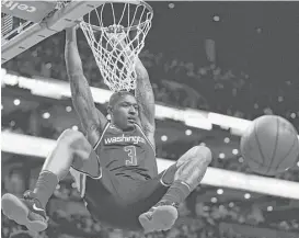  ?? Omar Rawlings / Getty Images ?? The Wizards’ Bradley Beal gets into the swing of things with two of his 25 points against the Celtics on Monday.