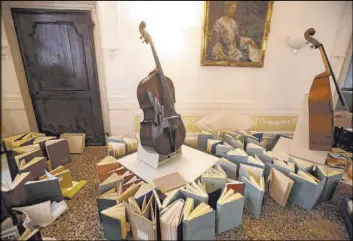  ?? Luca Bruno The Associated Press ?? Books are placed to dry Saturday on an upper floor of the Venice Music Conservato­ry after being recovered from the ground floor. High tidal waters returned to Venice on Saturday, four days after the city experience­d its worst flooding in 50 years.
