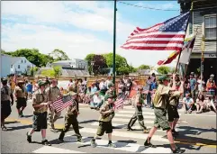  ?? SEAN D. ELLIOT/THE DAY ?? A Boy Scout troop marches up to the drawbridge in the 2015 Mystic Memorial Day Parade.