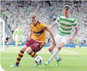  ??  ?? Chris Cadden in action against Mikael Lustig at Hampden yesterday