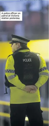  ??  ?? A police officer on patrol at Victoria station yesterday