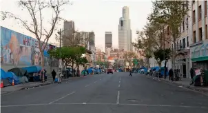  ??  ?? OFF THE BEATEN TRACK: (left to right) Night and day time shots of Downtown LA’s infamous ‘homeless neighbourh­ood’ Skid Row