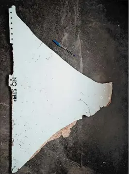  ?? BLAINE GIBSON AND AUSTRALIAN TRANSPORT SAFETY BUREAU ?? The triangular panel stenciled “no step” that Blaine Gibson found Feb. 27 has been confirmed as almost certainly a horizontal stabilizer from a Flight 370 wing.