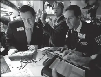  ?? — THE ASSOCIATED PRESS ?? Gregg Maloney, Patrick Murphy and Glenn Carell, left to right, work during the IPO of Antero Resources Corp. at the New York Stock Exchange Thursday.