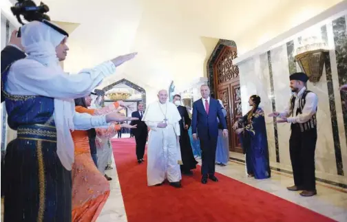  ?? Reuters ?? Pope Francis being received by Iraqi Prime Minister Mustafa Al Kadhemi at Baghdad Internatio­nal Airport on Friday.