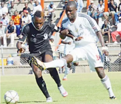  ??  ?? Highlander­s defender Tendai Ndlovu (right) tries to get the ball away from Tsholotsho’s MacClive Phiri during a Castle Lager Premier Soccer League match played Barbourfie­lds Stadium yesterday. Tsholotsho won the match 2-1 to boost their chances of...