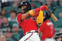  ?? AP PHOTO/JOHN BAZEMORE ?? Atlanta Braves pinch-hitter Ronald Acuña Jr. drives in the tying run with a double in the seventh inning Friday against the Miami Marlins.