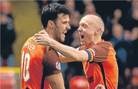  ??  ?? Scott Fraser celebrates with Willo Flood after a double in the 2-1 victory over Dunfermlin­e at Tannadice on Saturday.