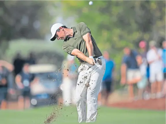  ?? Picture: AP. ?? Three-time Race to Dubai champion Rory McIlroy, who is three shots off leader Matt Wallace, plays his second shot at the 17th.