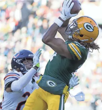  ?? WM. GLASHEEN / USA TODAY ?? Green Bay receiver Davante Adams catches a touchdown pass over Chicago cornerback Buster Skrine for an early lead Sunday.