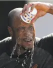  ?? Julio Cortez / Associated Press ?? Orioles outfielder Keon Broxton douses himself with water before Friday’s game.