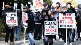  ?? The Canadian Press ?? Canadian Union of Postal Workers members picket Monday in front of the Canada Post regional sorting headquarte­rs in Halifax.