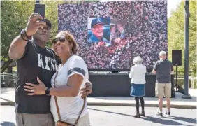  ?? AP PHOTO/BEN GRAY ?? On Saturday, Kevin and Ursula Jones take a photo in front of a video screen while attending the celebratio­n for President Jimmy Carter’s 99th birthday held at The Carter Center in Atlanta.