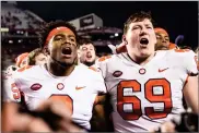  ?? SEAN RAYFORD AP PHOTO BY ?? Clemson quarterbac­k Kelly Bryant (2) and teammate Maverick Morris (69) celebrate after an NCAA college football game against South Carolina on Saturday in Columbia, S.C. Clemson defeated South Carolina 34-10.