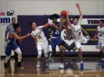  ?? BY RANDY MEYERS — FOR THE MORNING JOURNAL ?? Bay’s Cade Gergye (left) and Christian Dupps battle SPIRE’s Isaiah Jackson for a loose ball during the second quarter of a game at the Vermilion Tip Off Classic on Nov. 30.