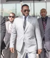  ??  ?? SUN-TIMES FILES R. Kelly walks with supporters out of the Leighton Criminal Courthouse in June 2019.