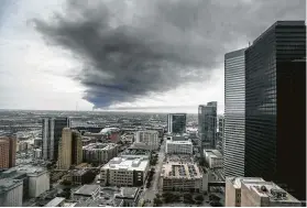  ?? Steve Gonzales / Staff photograph­er ?? A plume of smoke from the fire in Deer Park can be easily seen from the 31st floor of a downtown Houston office building Monday.