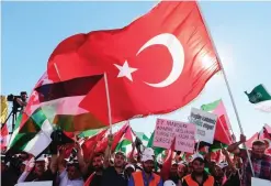  ??  ?? ISTANBUL: Protesters wave Turkish and Palestinia­n flags as they hold placards reading ‘Our hearts beat for Jerusalem’ during a demonstrat­ion yesterday. Thousands of supporters of a conservati­ve Turkish party rallied to protest against measures taken by...