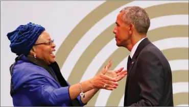  ?? Picture: REUTERS ?? CELEBRATOR­Y EMBRACE: Nelson Mandela’s widow, Graça Machel moves to embrace former US president Barack Obama after he delivered the 16th Nelson Mandela Annual Lecture in Joburg yesterday.