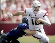  ?? NWA Democrat-Gazette/CHARLIE KAIJO ?? Razorbacks quarterbac­k Cole Kelley scrambles as Eastern Illinois linebacker Camden Meade defends Saturday. Kelley started the game and passed for 92 yards and one touchdown.