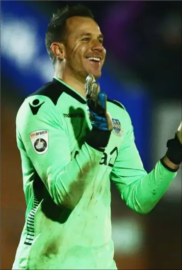  ??  ?? Eastleigh goalkeeper Ryan Clarke celebrates his side taking the lead against Swindon Town.