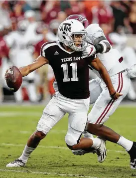  ?? Bob Levey / Getty Images ?? The Alabama defense had Texas A&M’s Kellen Mond on the run Saturday, but the freshman quarterbac­k channeled his inner Johnny Manziel when he had to and eluded the hard-rushing Crimson Tide on several occasions.