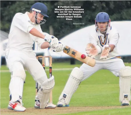  ?? Richard Birch ?? ● Pwllheli batsman Morgan Murray Williams hits out for the boundary watched by Bangor wicket keeper Sohaib Khan.