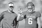  ?? [PHOTO BY BRYAN TERRY, THE OKLAHOMAN] ?? Oklahoma coach Lincoln Riley, left, and quarterbac­k Baker Mayfield talk before a game against West Virginia in Norman on Nov. 25, 2017.