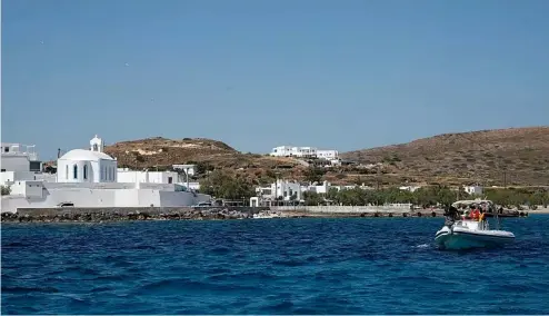  ?? ?? A dinghy leaves from the Aegean Sea island of Milos to Sikinos island, Greece.