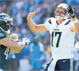  ?? Wally Skalij Los Angeles Times ?? CHARGERS quarterbac­k Philip Rivers wants an interferen­ce call as Eagles safety Chris Maragos exults in the incomplete pass in the second quarter.