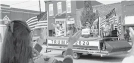  ?? NATIHARNIK/AP ?? Spectators applaud last month as aTrump 2020 float drives by during the annualAppl­ejack parade inNebraska City, Nebraska.