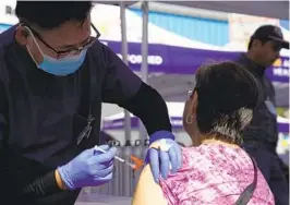  ?? MARK J. TERRILL AP FILE ?? Nurse Gigi Urcia gives a flu vaccinatio­n on Oct. 28 at a center in Lynwood.