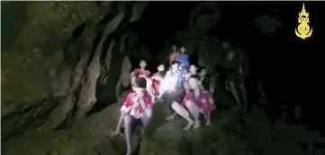  ??  ?? Boys from an under-16 soccer team and their coach wait to be rescued after they were trapped inside a flooded cave in Chiang Rai,Thailand, in this still image taken from a Thai Navy Seal handout video. — Reuters photo