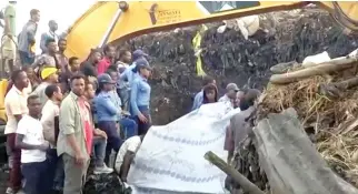  ??  ?? People gather at the site after a landslide at a garbage dump on the outskirts of Addis Ababa, Ethiopia in this still image taken from a video from March 12. (Reuters)