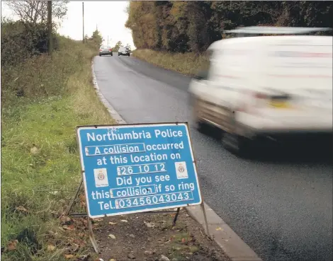  ??  ?? POLICE APPEAL: The sign left by the roadside after the fatal accident.