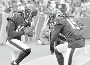  ?? AP Photo/Mark Zaleski ?? ■ Houston Texans wide receiver DeAndre Hopkins celebrates with Will Fuller (15) after Hopkins scored a touchdown on a 28-yard play against the Tennessee Titans in the first half of an NFL football game Sept. 16 in Nashville, Tenn.