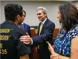  ?? Annie Mulligan ?? Mayor Jeff Wagner greets Cesar Espinosa after being sworn into office Saturday at Pasadena City Hall. He won in a runoff last month to succeed Johnny Isbell.