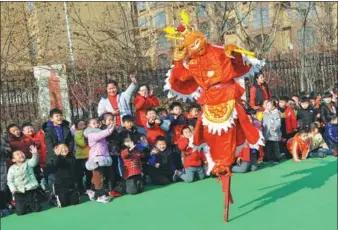  ?? LI ZONGXIAN / FOR CHINA DAILY ?? A performer in a Monkey King costume walks on stilts during a show for children at a kindergart­en in Zaozhuang, Shandong province, on Tuesday. Performanc­es on stilts are part of the city’s intangible cultural heritage.