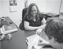  ??  ?? Beth Hammer watches sixth-grader Andrew Robertson work through a word problem at the Tenney School last month.