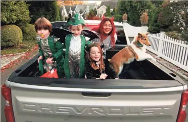  ?? Christian Abraham / Hearst Connecticu­t Media ?? Children sit in the back of the family pickup truck as they go trick or treating in Rowayton on Saturday.