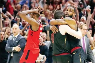  ?? GREGORY SHAMUS/GETTY IMAGES/AFP ?? LeBron James, #23 of the Cleveland Cavaliers, celebrates his game-winning shot with Kevin during Game 3 of the Eastern Conference Semifinals during the NBA Playoffs at Quicken Loans Arena on Saturday in Cleveland, Ohio.