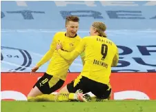  ?? — AFP file photo ?? Dortmund’s Marco Reus (left) celebrates after scoring a goal with Erling Braut Haaland during the first leg match against Manchester City and at the Etihad Stadium in Manchester, north west England.