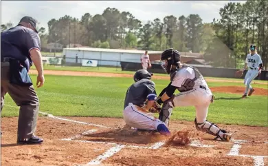  ?? Steven Eckhoff ?? Coosa catcher Ryan Smith tags out a Fannin County runner at the plate during the first inning of Thursday’s Region 7-AA contest against Fannin County.