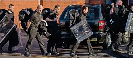  ??  ?? Aftermath: Prison officers leave after regaining control of Birmingham Prison in December 2016