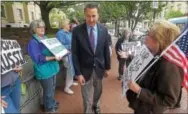  ?? PHOTOS BY PETE BANNAN — DIGITAL FIRST MEDIA ?? Claire Witzleben of Tredyffrin, right, talks to U.S. Rep. Ryan Costello as he walks past protesters who gather every Friday outside his West Chester office.