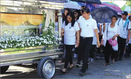  ??  ?? The parents of Jastine Valdez follow her coffin to the funeral service at St Joseph’s Catholic Church in Aritao, Nueva Vizcaya, the Philippine­s. Photo: Leander C Domingo/The Valley Journal