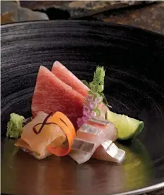  ??  ?? Pristine sashimi is sliced and served by Shinji’s masterchef Oshino in the smaller dining room.