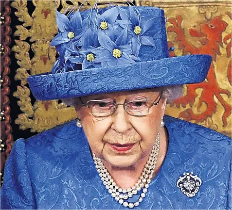  ??  ?? The Queen gave her speech at the State Opening of Parliament without her full regalia for the first time since 1974. Her hat, which had echoes of the EU flag, drew considerab­le attention